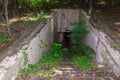 The entrance to secret disguised military bunker. Abandoned bomb shelter. Background