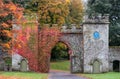 Entrance to Stourhead National Trust property near Warminster in Wiltshire UK. Photographed in autumn with virginia creeper ivy