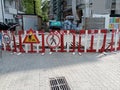 Entrance to the territory of the construction site. The construction site is surrounded by a fence with road signs. Royalty Free Stock Photo