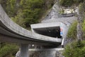 Entrance to a tunnel on a highway, pass trough mountain. Entry from flyover to road tunnel, highway in mountains, drive through Royalty Free Stock Photo