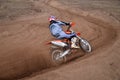 Entrance to turn the sandy track racer of motocross motorcycle w Royalty Free Stock Photo
