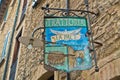 Entrance to very old trattoria in medieval building, a detail from the streets from Voltera, Tuscany