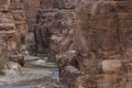 Entrance to the Wadi Mujib canyon in Jordan. Steep rocks and a rapid flowing river carved. Difficult crossing and attraction for