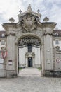 entrance to the white baroque and neoclassic palace with beautiful carved decorative elements. Black gates with wrought iron Royalty Free Stock Photo