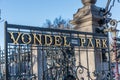 Entrance of the Vondelpark with the cast iron green fence with golden letters against blue sky Royalty Free Stock Photo
