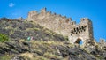 Entrance and wall of the ruins of Tourbillon castle with tourist going up the hill in Sion Switzerland