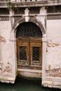 Closeup of the facade of a building, on the streets of Venice, Italy. Entrance from the water to the building. Antique Royalty Free Stock Photo