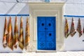 Entrance wiht colorful door and carpets in Kairouan, Tunisia