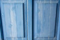 Entrance wooden door with blue shutters details Royalty Free Stock Photo