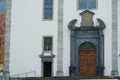 An entrance wooden gate, facade or door of Engelberg Abbey, Benedictine monastery and the St. Jacob chapel in spring time