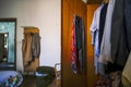 entrance with wooden hanging clothes in abandoned house