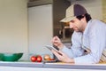 Entrepeneur using his phone in his takeaway food stall