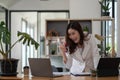 Entrepreneur of beautiful business asian young woman working with laptop and celebrating at home with her work success Royalty Free Stock Photo