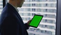 Entrepreneur browsing chromakey tablet data at business center window closeup. Royalty Free Stock Photo