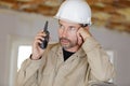 entrepreneur on building site using walkie talkie