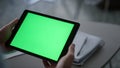 Entrepreneur hands holding tablet looking screen chroma key in workplace cafe.