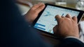 Entrepreneur hands using tablet check finance graphics on business trip closeup