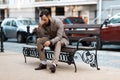 The entrepreneur has financial problems. A man with a headache sits outdoors. Fatigue after work and stress Royalty Free Stock Photo