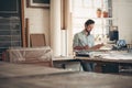 Entrepreneur in his workshop checking figures on a clipboard Royalty Free Stock Photo