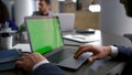 Entrepreneur man searching laptop green screen on diverse business team meeting.