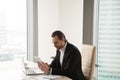 Entrepreneur using tablet while sitting at desk Royalty Free Stock Photo