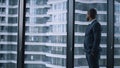 Entrepreneur walking corporate building. Businessman looking window in office. Royalty Free Stock Photo