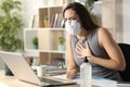 Entrepreneur with mask due covid-19 wheezing at homeoffice Royalty Free Stock Photo