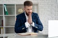 Entrepreneur writing notes sitting at his desk. Young man making business plans with papers and computers on his desk Royalty Free Stock Photo