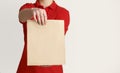 Entrust fragile items to courier. Courier holds out paper bag to client Royalty Free Stock Photo