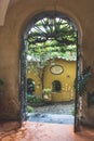 Entry of a building with a black wrought iron door