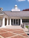 Entry doors to a library by a brick sidewalk