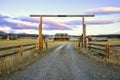 Entry gate to a nice wooden ranch home with beautiful landscape. Royalty Free Stock Photo