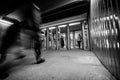 Entry in Kyiv underground with moving blurry people and bright station light.