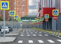 Entry prohibited road marking zebra and many road traffic signs pedestrian crossing street and parking