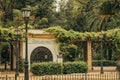 Entry of a reding point surrounded by lush greenery in Seville, Spain