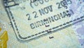 Entry stamp in passport made by immigration officer at border and visa control at Birmingham airport in United Kingdom. Selective