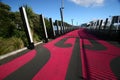 Lightpath with painted red Maori motif. Walkway in pink color for bicycle riders. Nelson Street Cycleway, Auckland, New Zealand Royalty Free Stock Photo