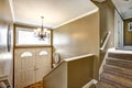 Entryway in American home with mocha walls and staircase