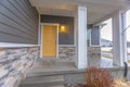 Entryway of a home with stairs going up to the front porch and door