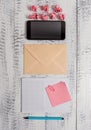 Envelop squared notepad colored sticky note clip binder paper balls smartphone lying wooden retro vintage old rustic