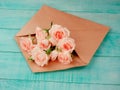 Envelop with white card and rose background. Top view., Envelope with flowers summer, spring.