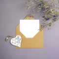 Envelope with blank card, vintage toy heart and flowers on gray background. Valentines day, womens day concept, top view Royalty Free Stock Photo
