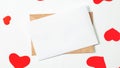 Envelope with blank note mockup inside and red hearts on a white background. Valentines day and romantic concept. Flat lay. Copy Royalty Free Stock Photo