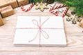 Envelope with blank sheet of paper on Christmas background - fir branch, pine cones, red ribbon, star and heart of sweets. Space Royalty Free Stock Photo