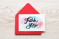 Envelope and card with phrase Thank You on light wooden table, top view Royalty Free Stock Photo