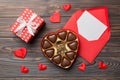 Envelope on colored background for Valentine Day with gift box and chocolate. Heart shaped with gift box of chocolates Royalty Free Stock Photo