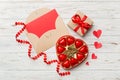 Envelope on colored background for Valentine Day with gift box and chocolate. Heart shaped with gift box of chocolates Royalty Free Stock Photo