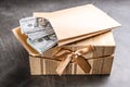 Envelope with dollar bills and gift box on stone table Royalty Free Stock Photo