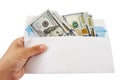 An envelope with dollars in hand is isolated on a white background. a lot of dollars in an envelope. Close-up. Royalty Free Stock Photo