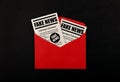 Envelope with FAKE NEWS newspapers over black Royalty Free Stock Photo